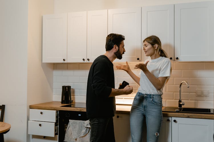 Man And Woman Arguing In A Kitchen