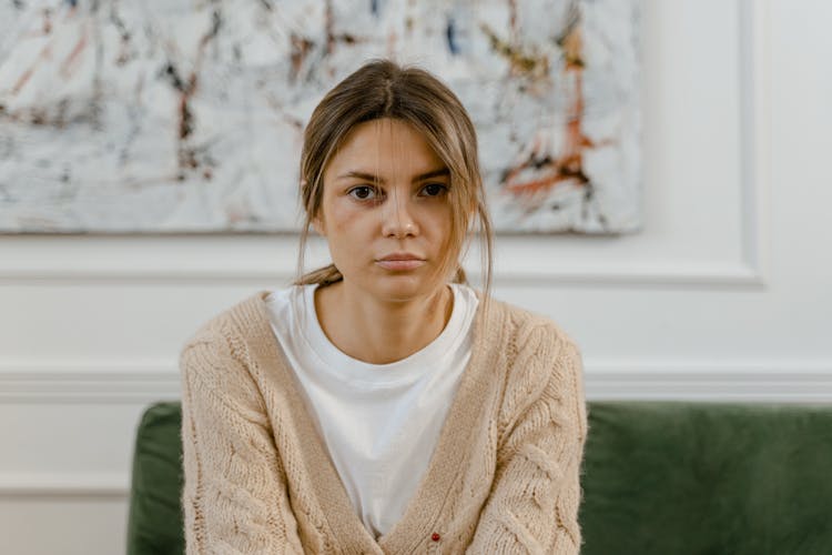 Woman With Messy Hair Sitting On The Couch 