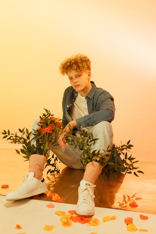 Photo of a Boy with Green Leaves in His Socks