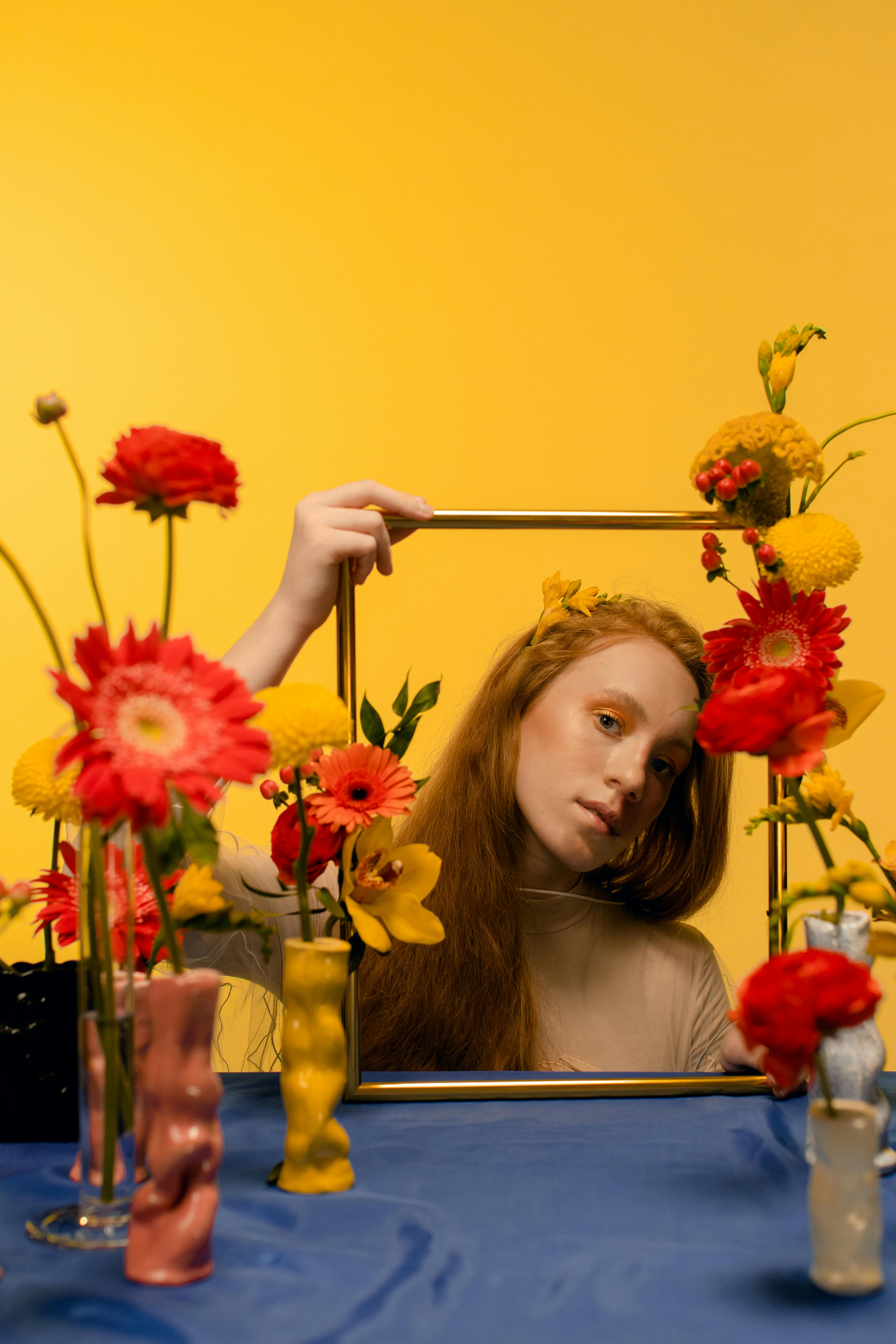 a woman holding a gold frame