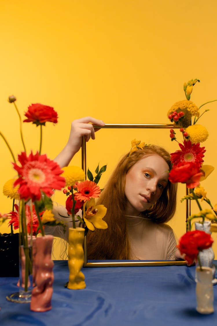 A Woman Holding A Gold Frame 