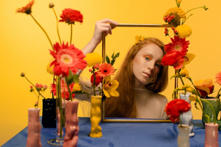 A Woman Holding A Gold Frame 