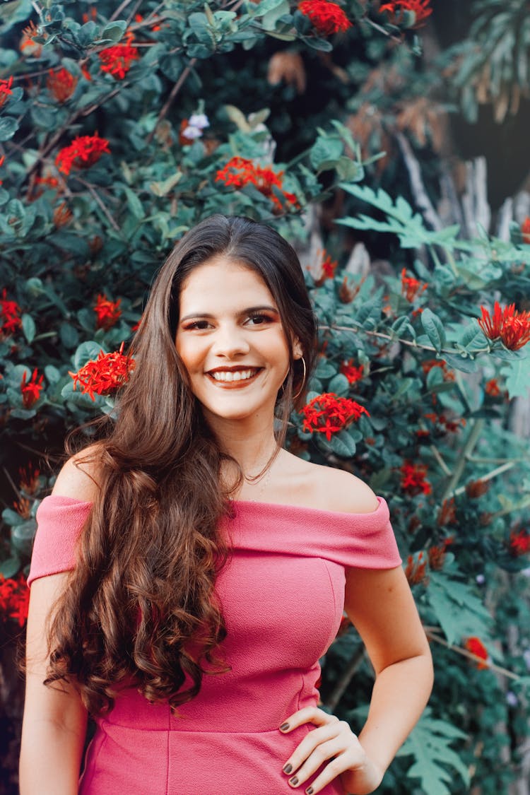 Woman Standing In Front Of Flowering Plants