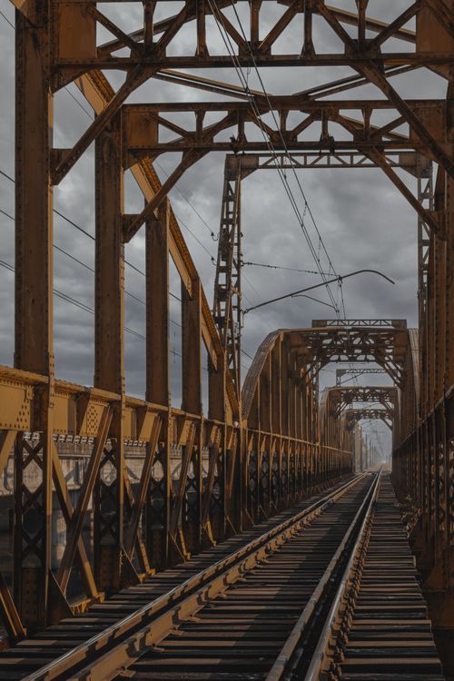 Free A dramatic view of a steel railway bridge in Linares, showcasing intricate industrial design. Stock Photo