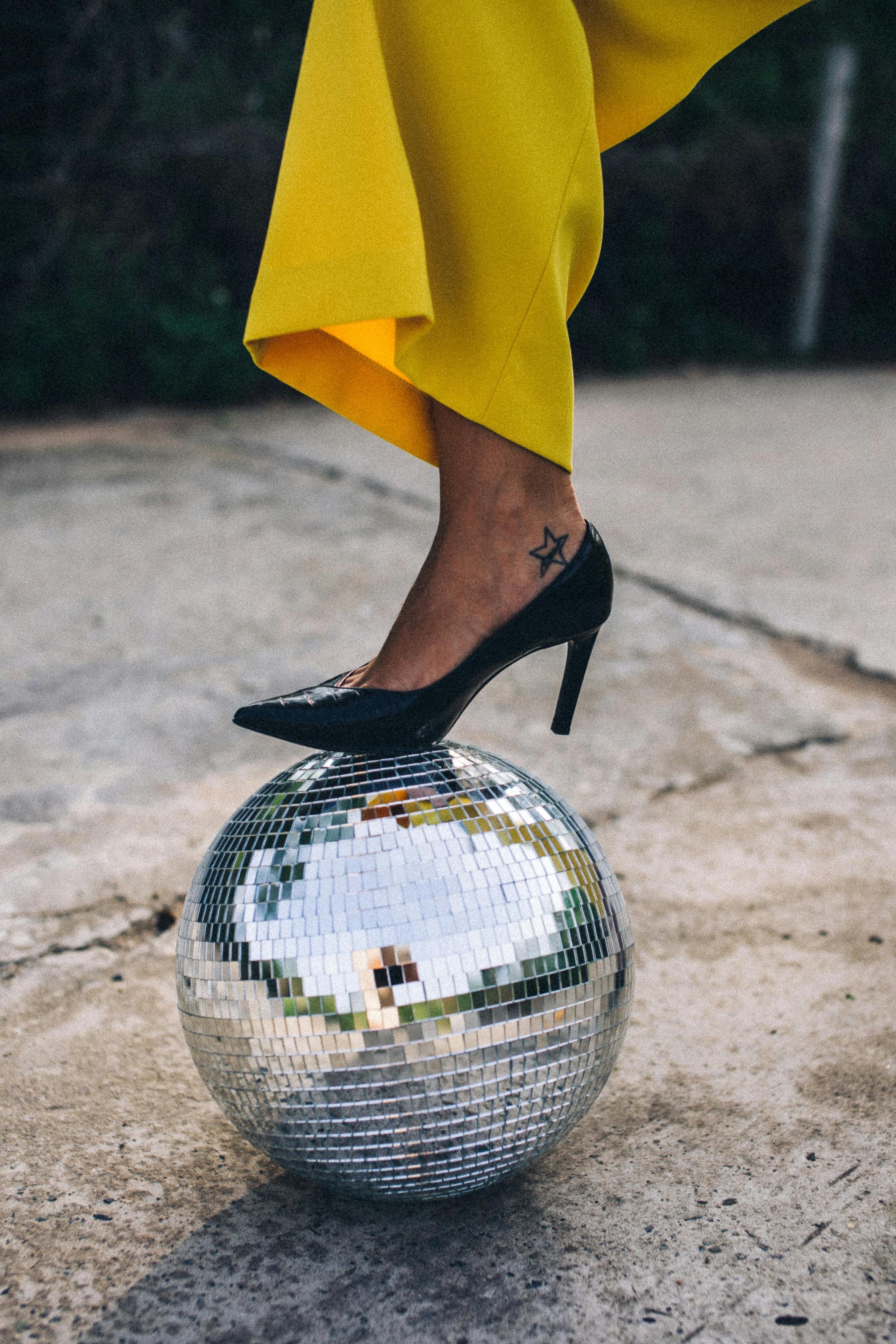 a woman stepping on a disco ball