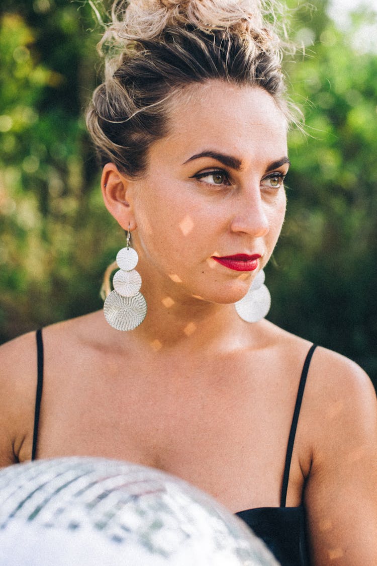 Woman In Black Spaghetti Strap Top With Silver Earrings