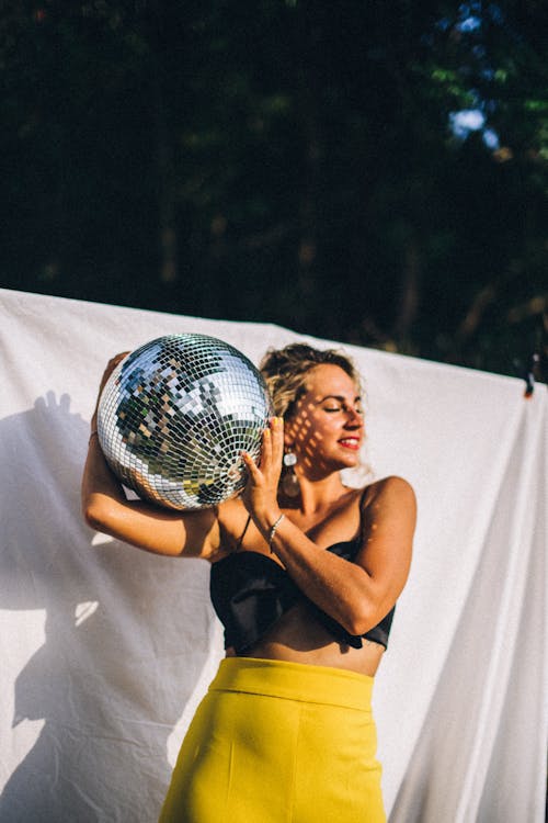 A Woman Holding a Disco Ball
