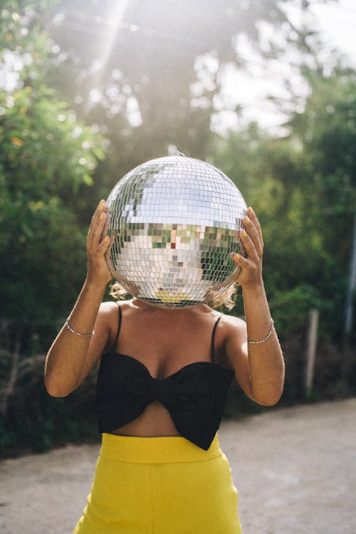 A Woman Holding a Disco Ball