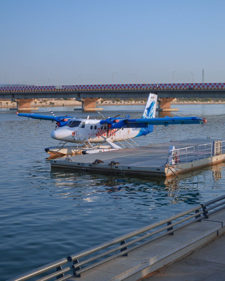 White And Blue Airplane Floating On The Sea