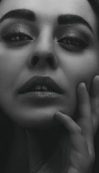 Artistic monochrome portrait of a woman in a contemplative pose.