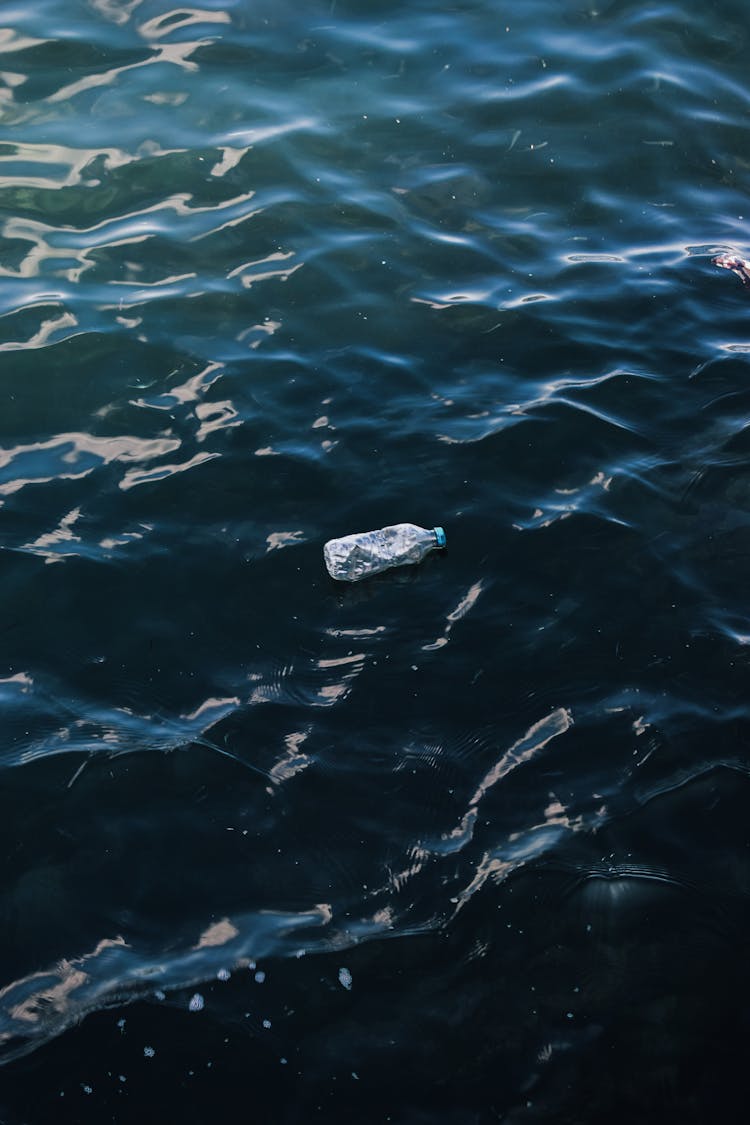 A Bottle Floating On The Water Surface