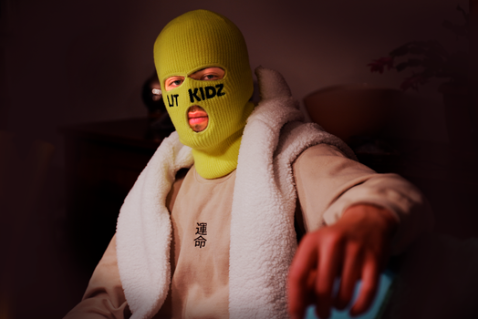 Person in Yellow Knit Cap and White Sweater
