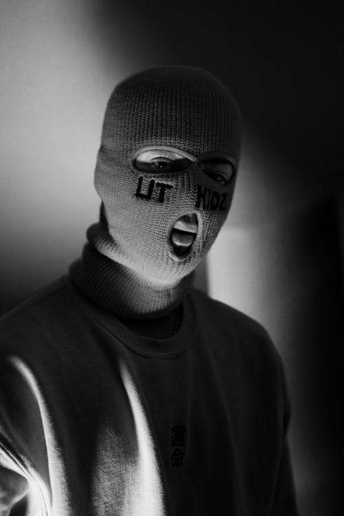 Grayscale Photograph of a Man Wearing a Ski Mask