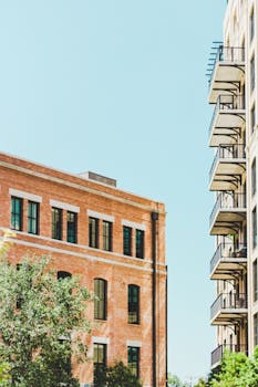 View of modern buildings with balconies against a clear blue sky in San Antonio.