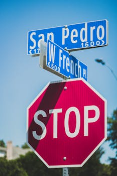 Intersection of San Pedro and W French with clear street signs and stop sign.