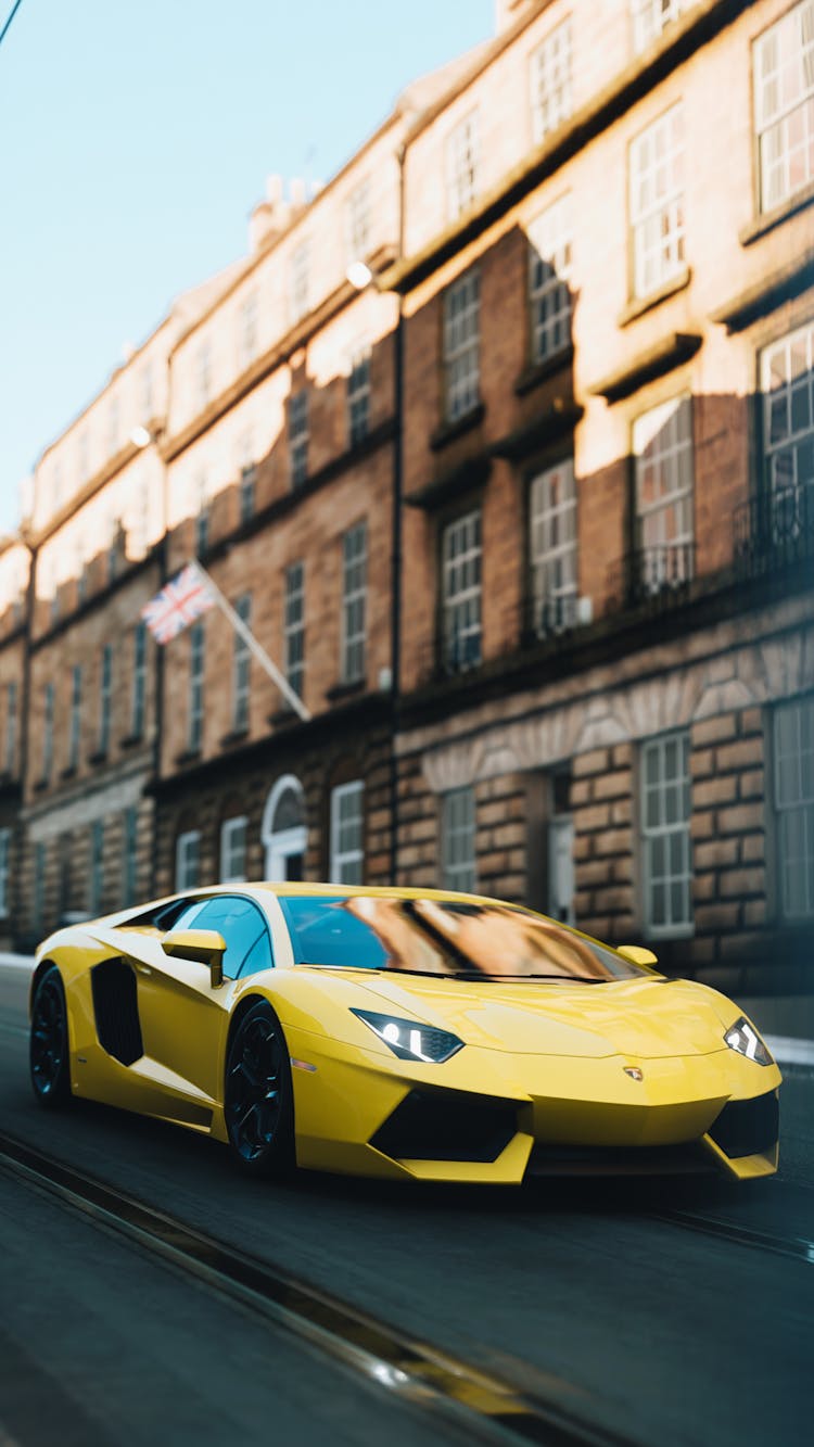 Yellow Car On The Road Near Buildings