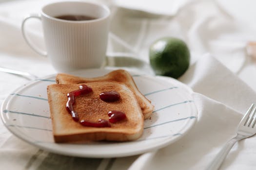 A playful and inviting breakfast scene with smiley face toast and coffee.