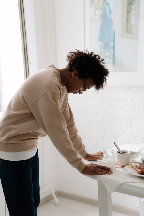 Free Person deep in thought by a table with a coffee cup indoors. Stock Photo