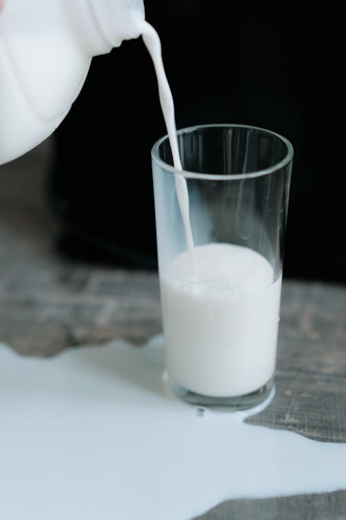Free Photo Of Spilled Milk in Clear Drinking Glass Stock Photo