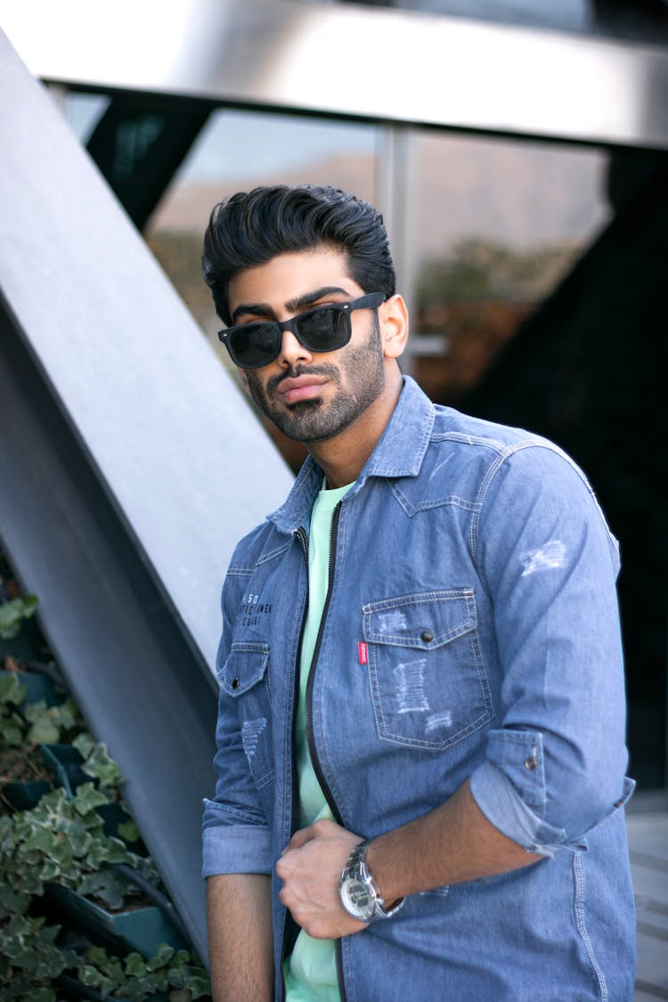 Man In Blue Denim Button Up Shirt Wearing Black Sunglasses