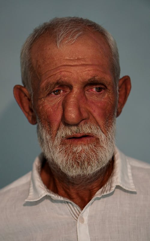Portrait of an Elderly Man in a White Collared Shirt