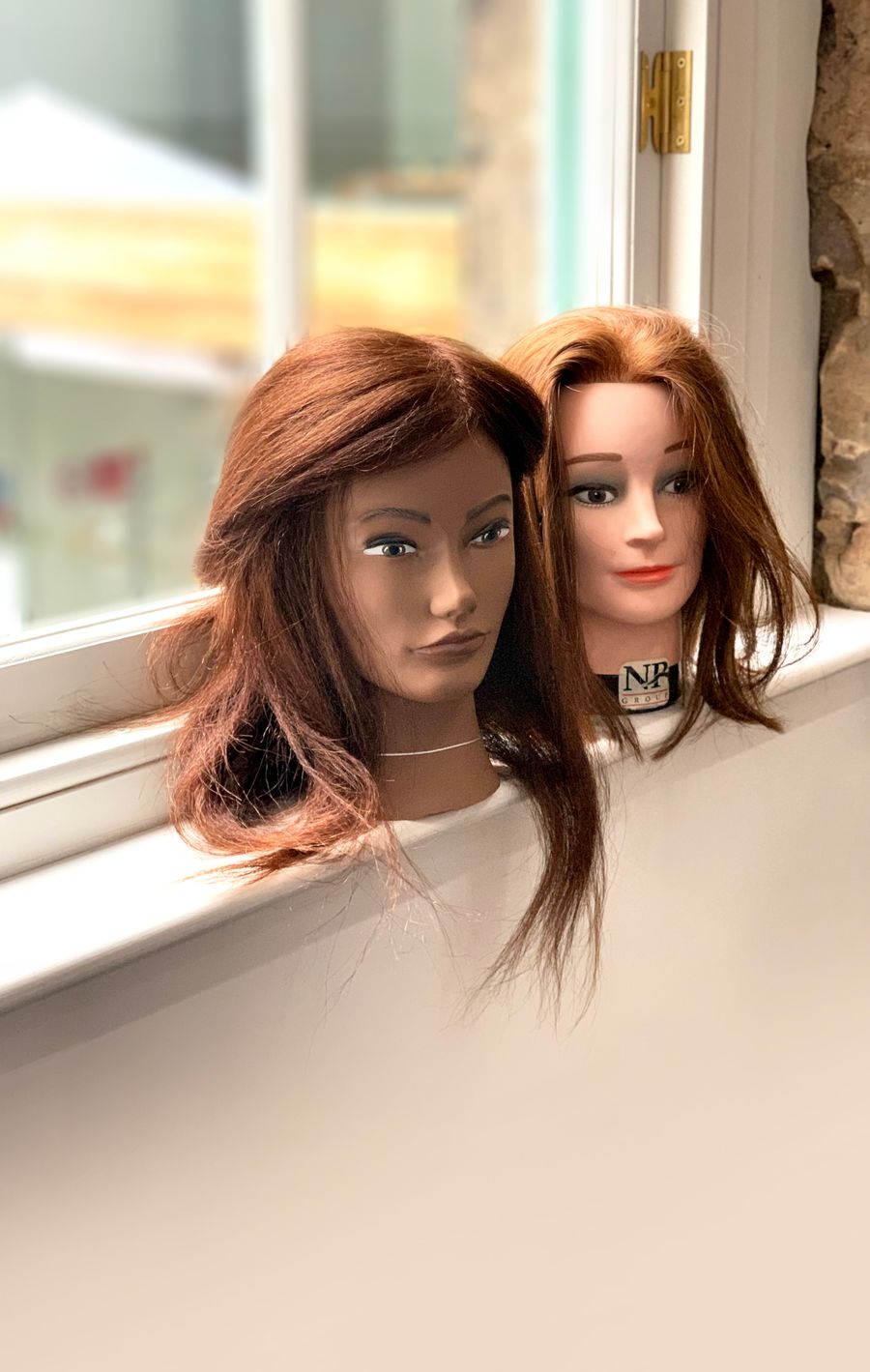 Styled wigs on display heads
