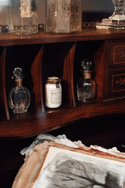 Bottles and Containers Displayed on Wooden Shelves