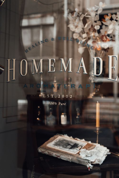 Free Charming store window display featuring vintage aromatherapy decor and elegant typography. Stock Photo