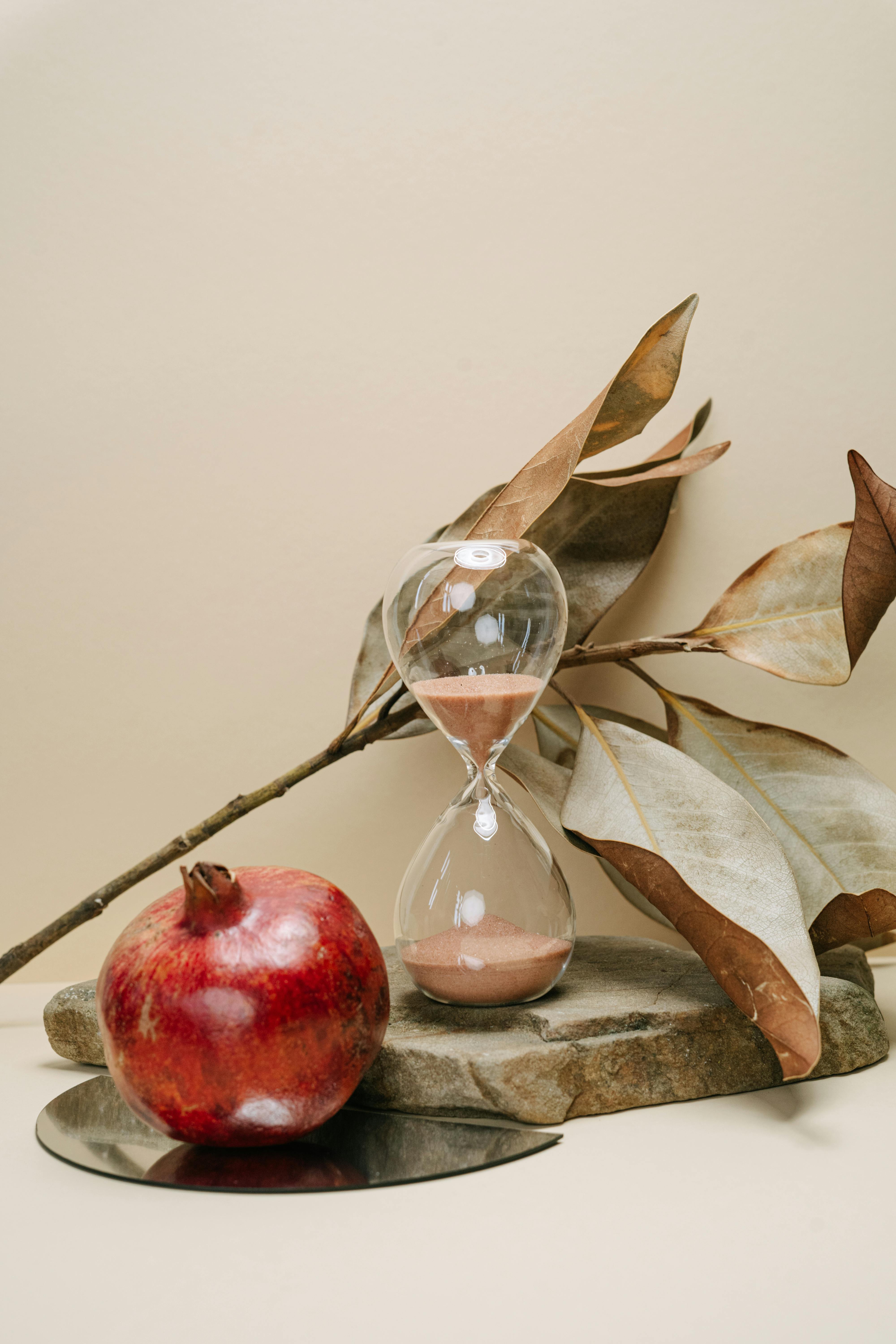 clear glass hour glass on brown wooden surface