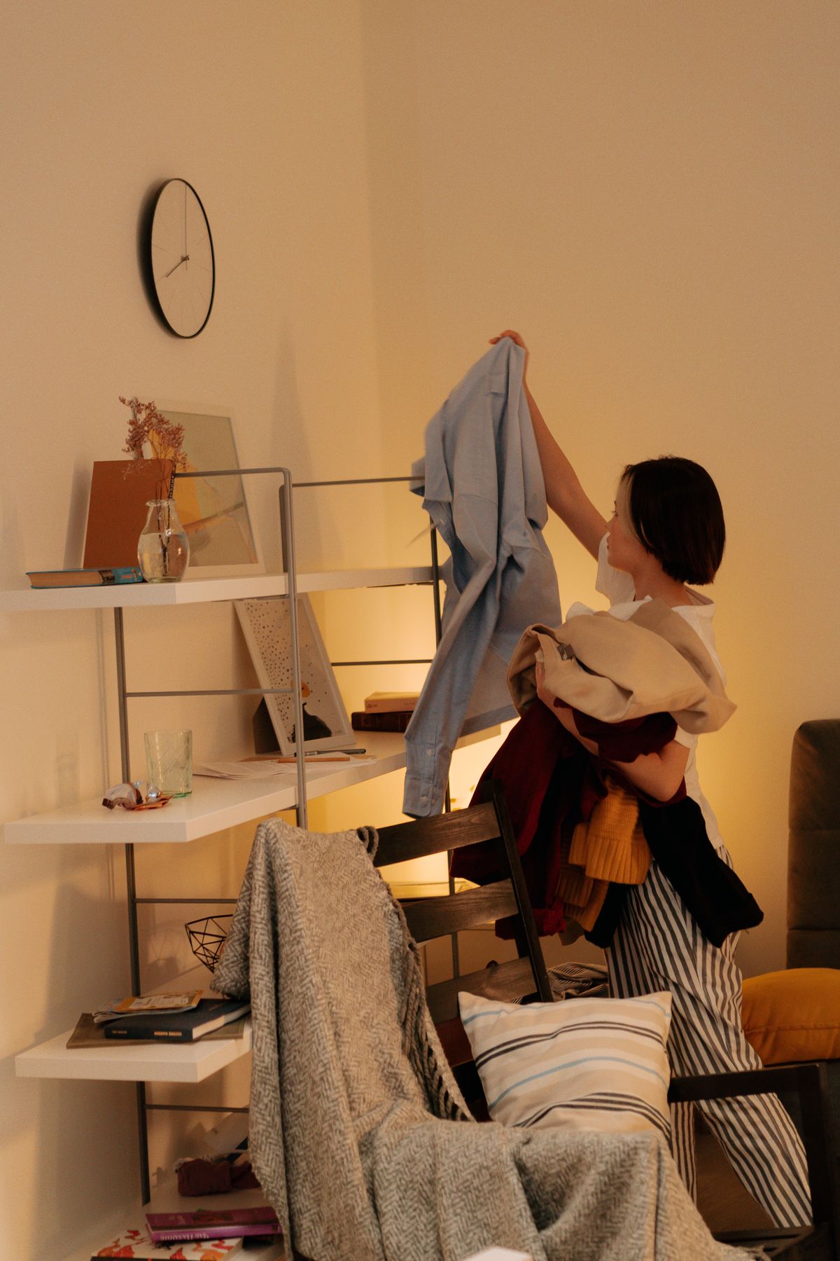 Woman organizing and cleaning a bedroom