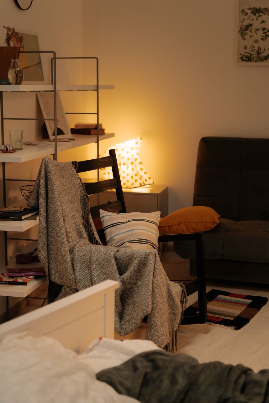 The same living room fully cleaned, organized, and spotless from the matching camera angle