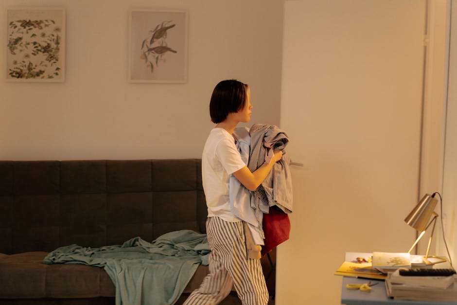 Person doing laundry comfortably at home - apartments with in unit laundry Person doing laundry comfortably at home - apartments with in unit laundry