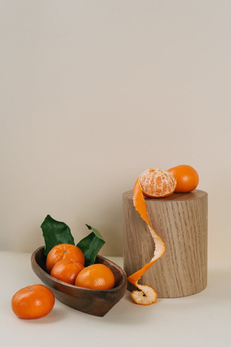 Tangerines On A Wooden Tray And A Round Wooden Block