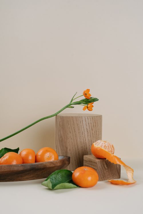 Free Aesthetic arrangement of mandarins and flowers on wooden blocks, showcasing fresh citrus and minimalistic beauty. Stock Photo