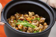 Orange and White Seashell Dish in Black Round Bowl