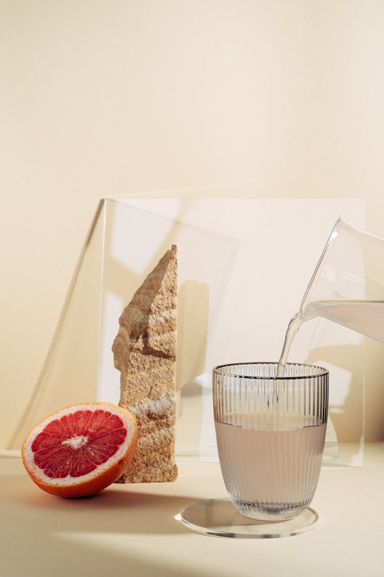 Photo Of A Slice Of Grapefruit Near A Drink