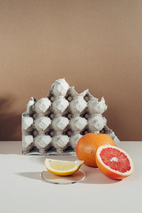 Sliced Citrus Fruits on White Surface