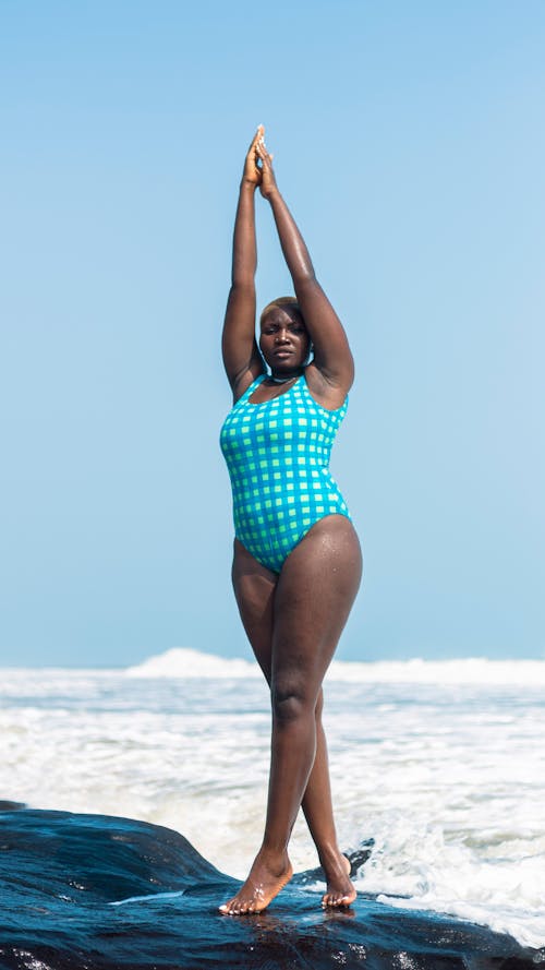 Free A Woman wearing Swimwear Standing on the Rock Stock Photo