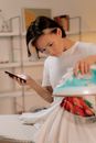 Woman in White T-shirt Using Smartphone