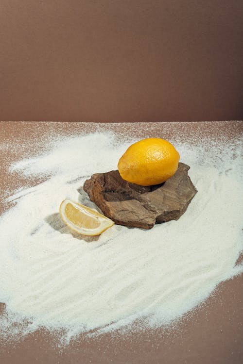 Free Lemons On White Sand Stock Photo