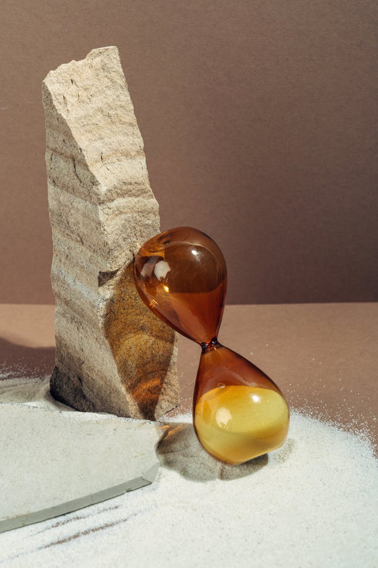 Sand Amber Glass Leaning On Stone