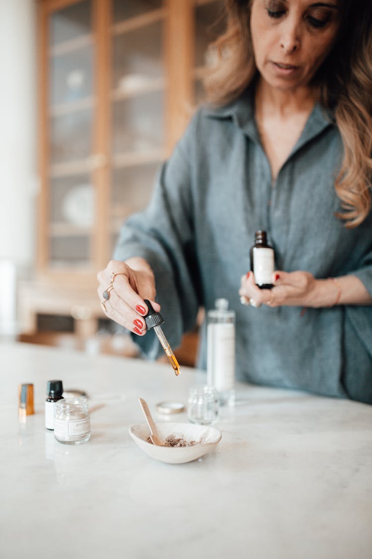 Woman Pouring From Flask To Bowl