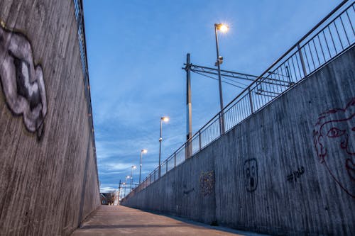 Free Alley Between Concrete Walls with Street Lamps Stock Photo