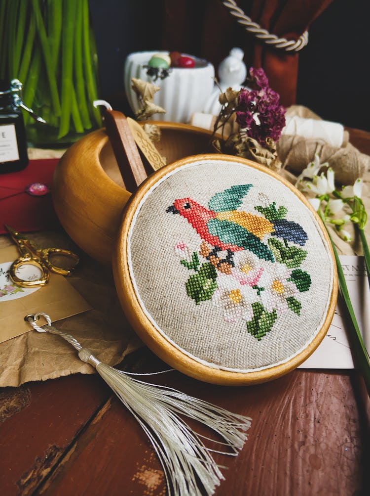 Beautiful Cross Stitch Project Leaning On Wooden Bowl