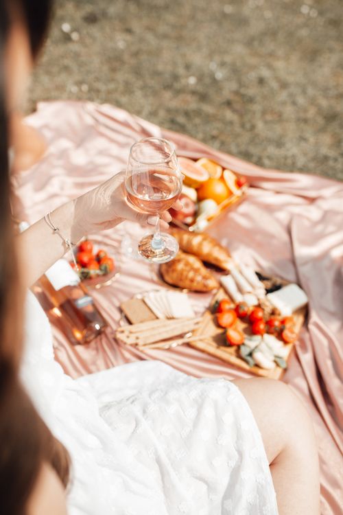 Free A stylish outdoor picnic featuring wine, cheese, and fresh fruits. Stock Photo