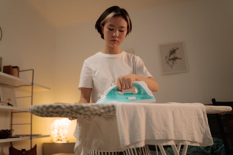 A Young Woman Ironing Clothes