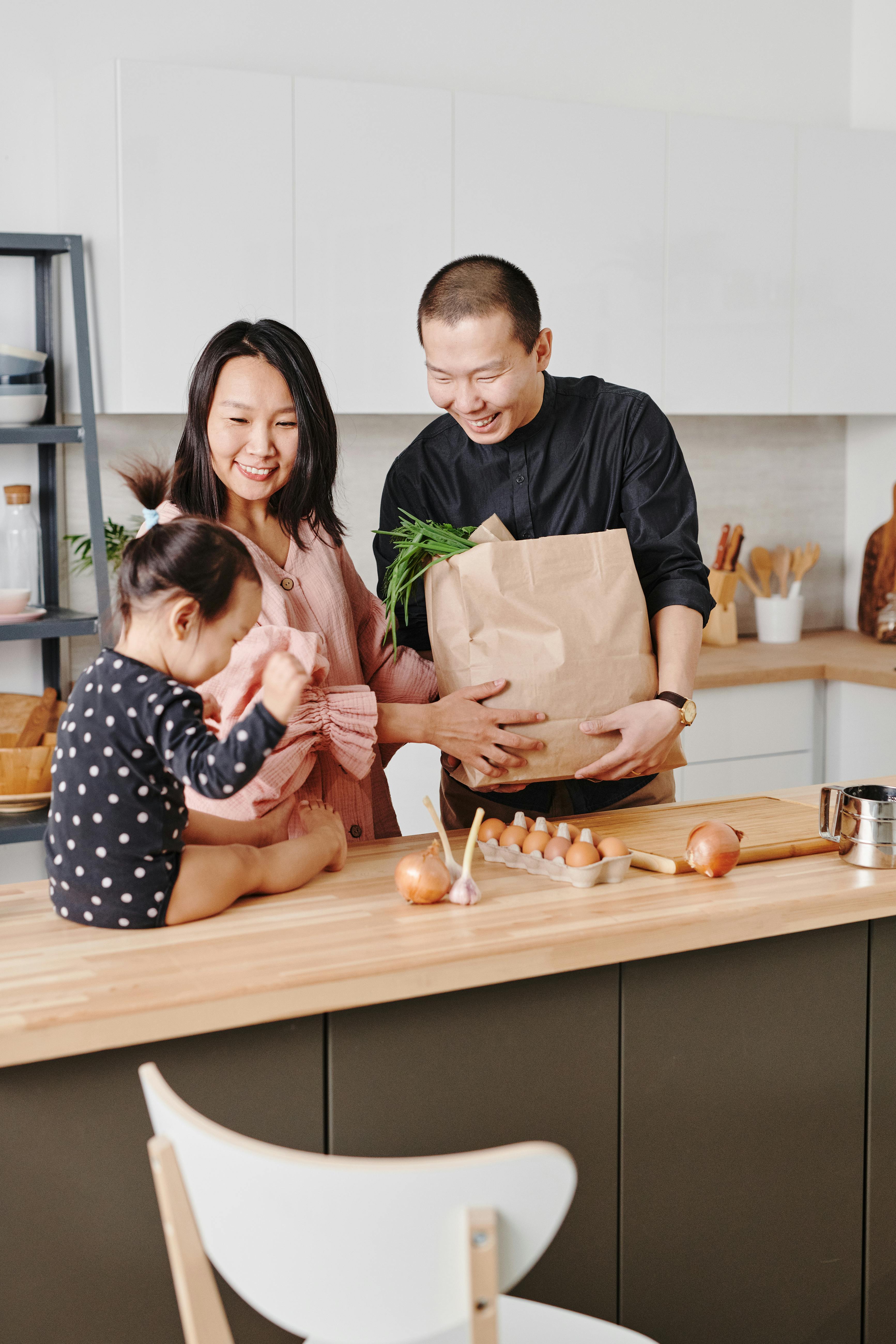 couple standing at counter with their baby