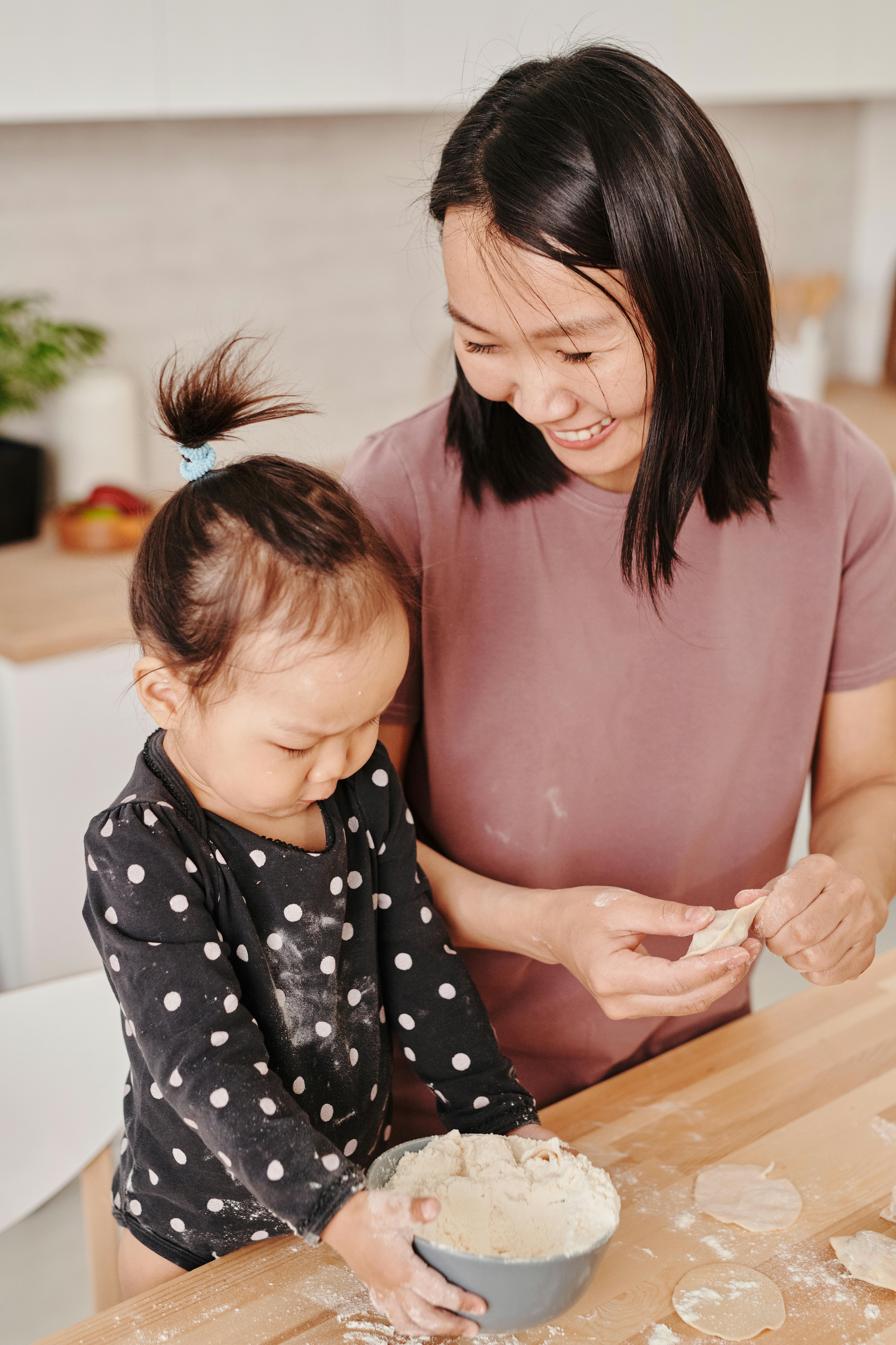 mother and daughter preparing food together