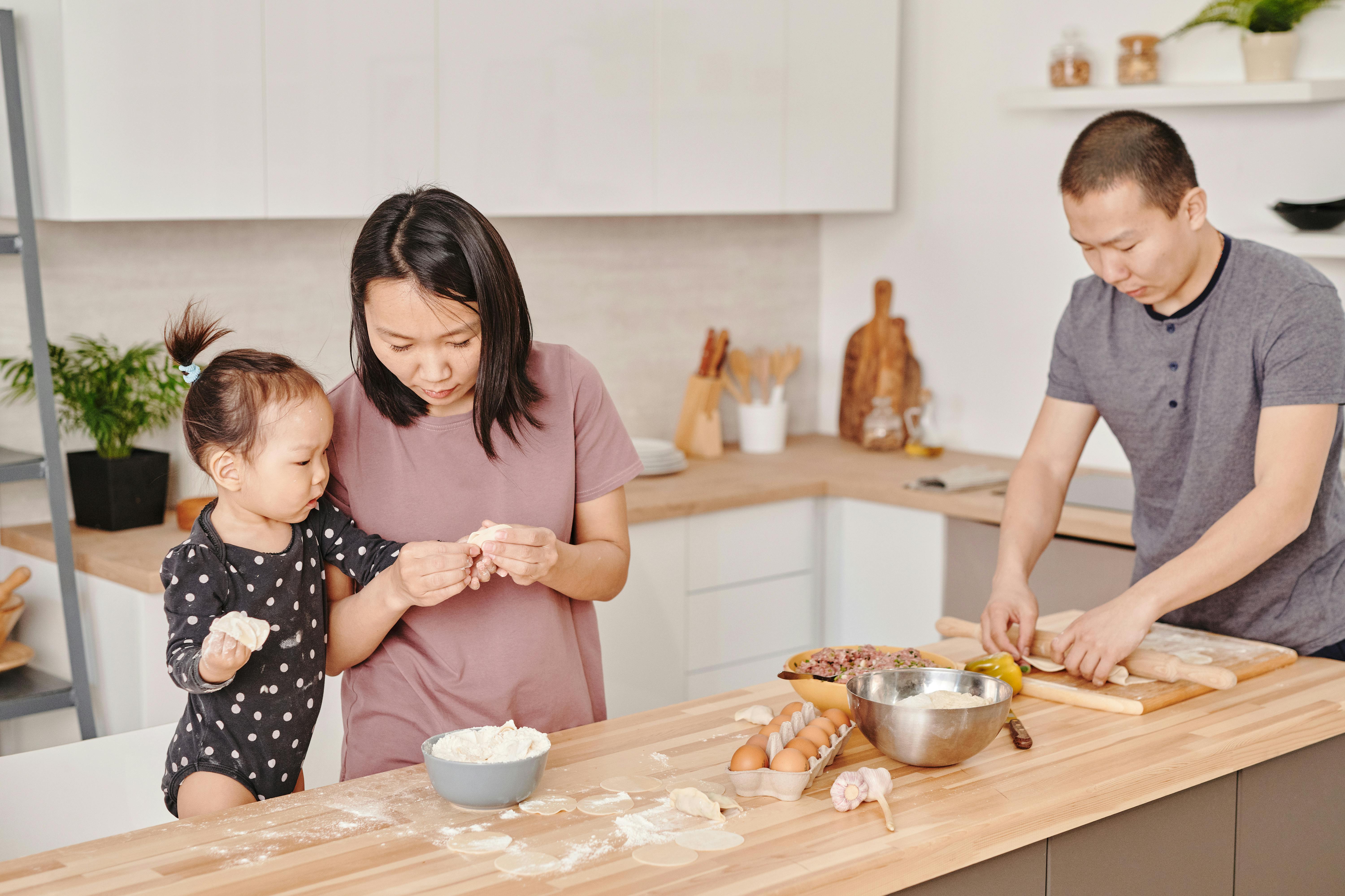 woman holding dumpling with her daughter