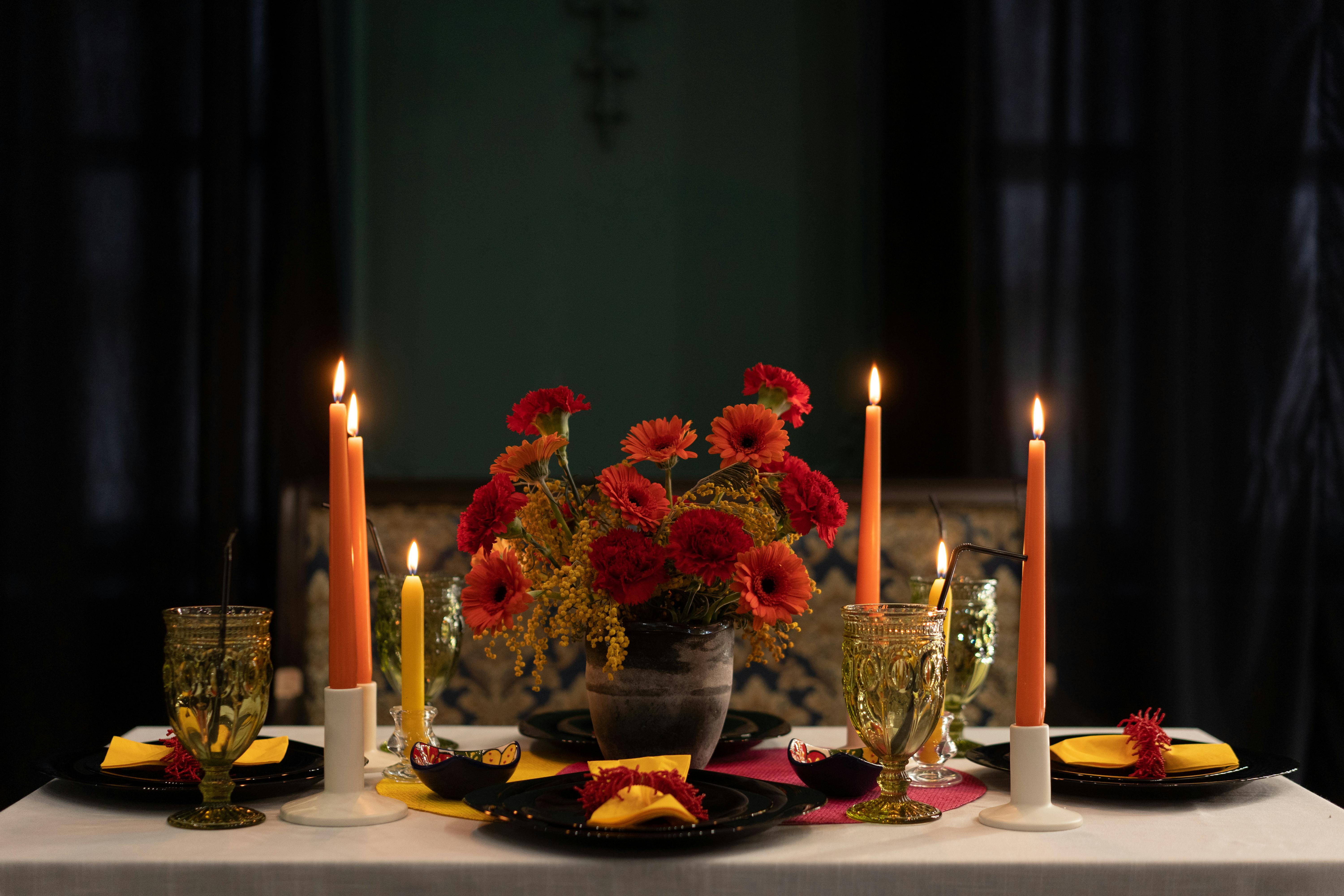 Flower pot on table with candle along side